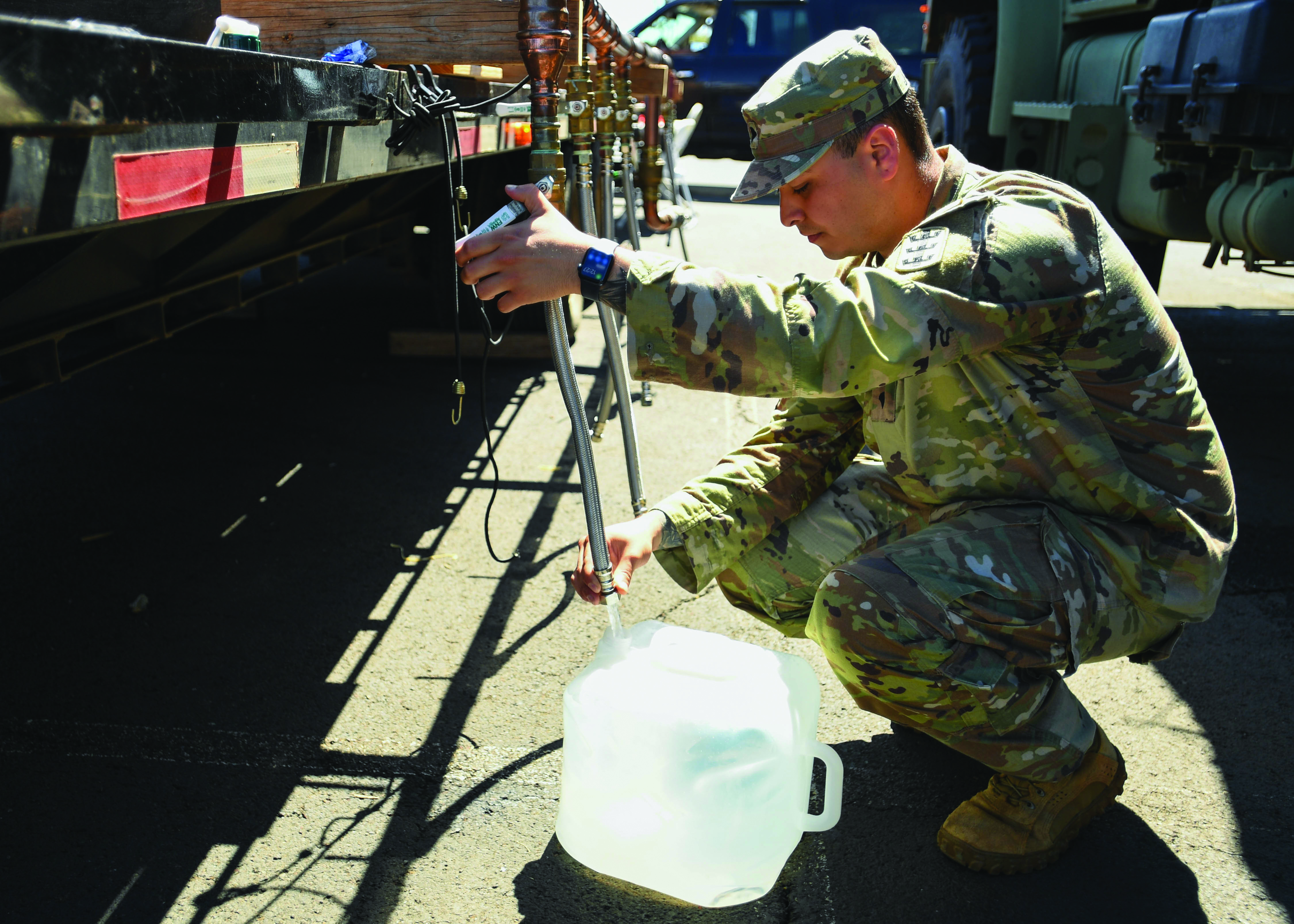 A Soldier stationed in Hawaii fills a bulk water container at the Navy Exchange Moanalua Terrace water distribution station. The U.S. Navy is working closely with
        the Hawaii Department of Health, U.S. Environmental Protection Agency, and the U.S. Army to restore safe drinking water to Joint Base Pearl Harbor-Hickam
        housing communities through sampling and flushing, and the recovery of the Red Hill Well. (Credit: Mass Communication Specialist 2d Class Chelsea D. Meiller)